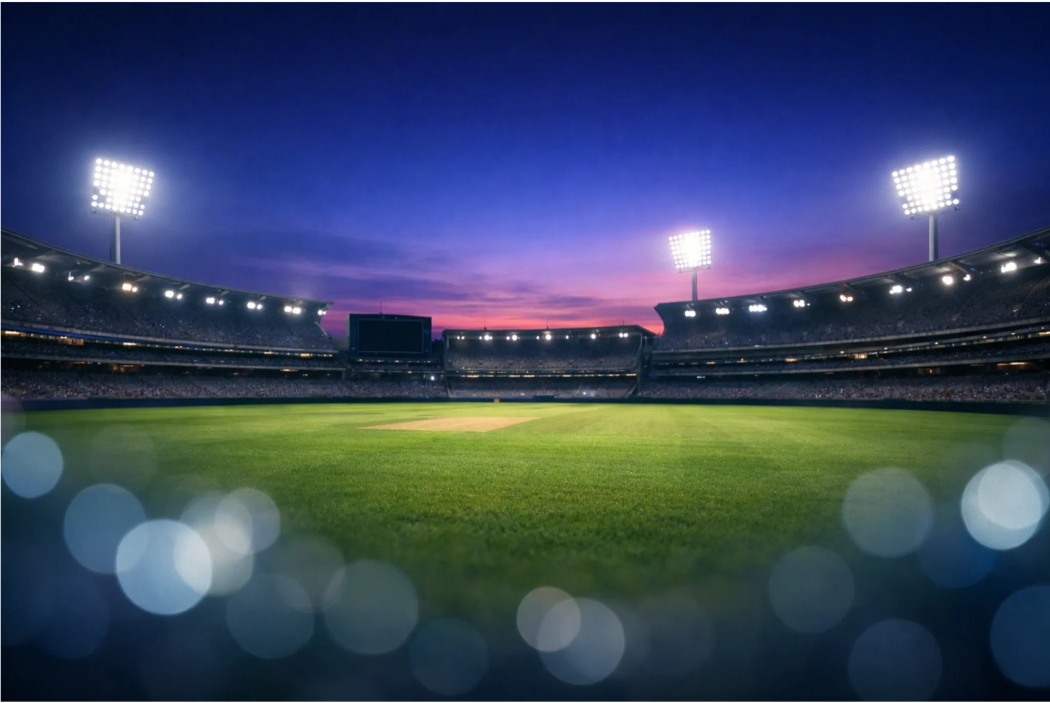 Cricket ground under evening lights